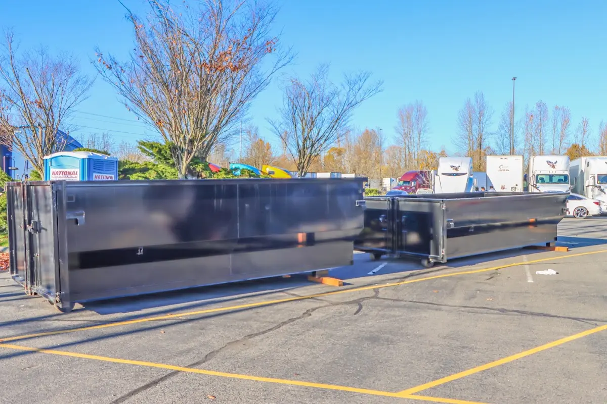 Professional dumpster rental service with roll-off container on residential driveway in St. Michael